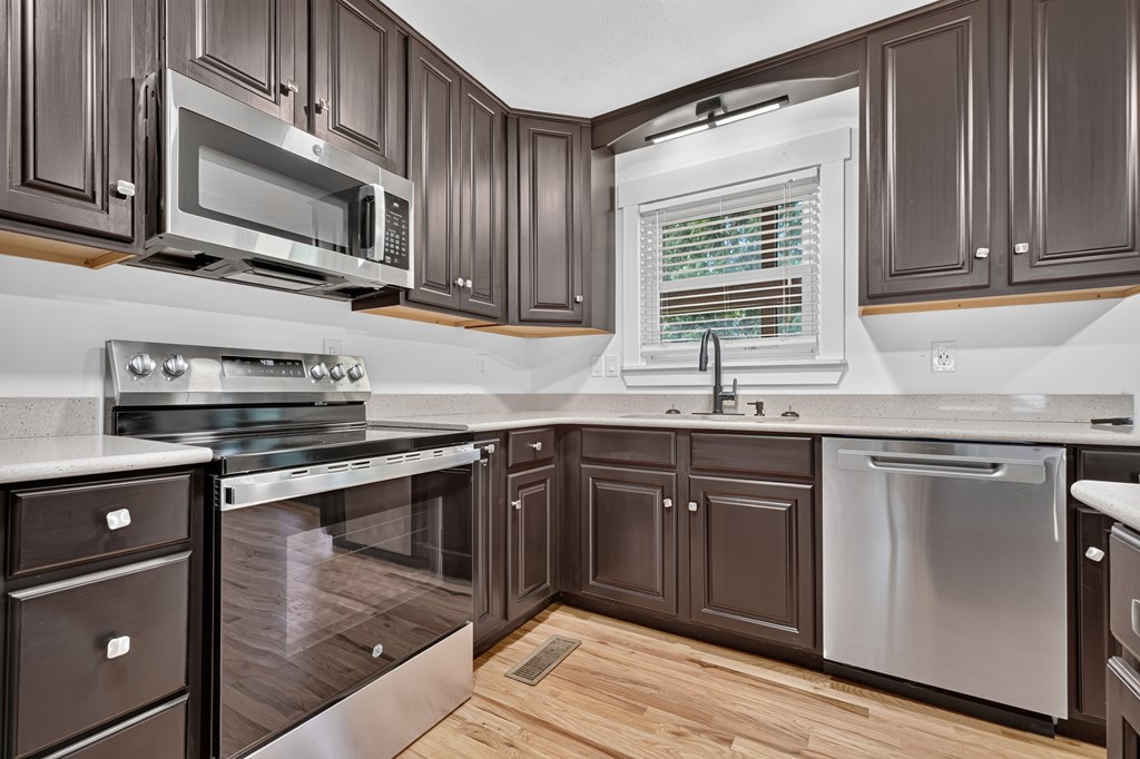975 Goss Road Epworth, GA 30541 - Photo 48 of 58 a kitchen with stainless steel appliances granite countertop a sink stove and microwave