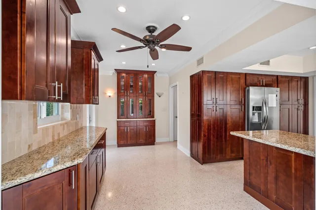 a kitchen with granite countertop stainless steel appliances and wooden cabinets