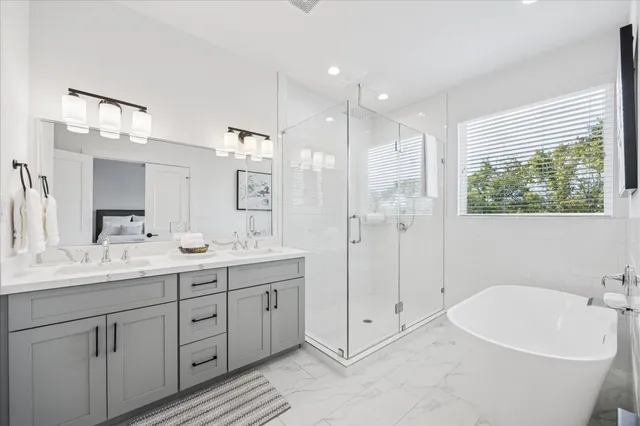 a bathroom with a sink a toilet and shower