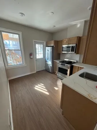a kitchen with a stove a sink and a microwave