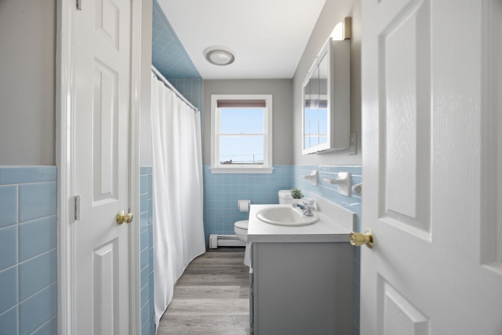 192 Swifts Beach Road Wareham, MA 02571 - Photo 26 of 38 a bathroom with a sink a mirror and a window