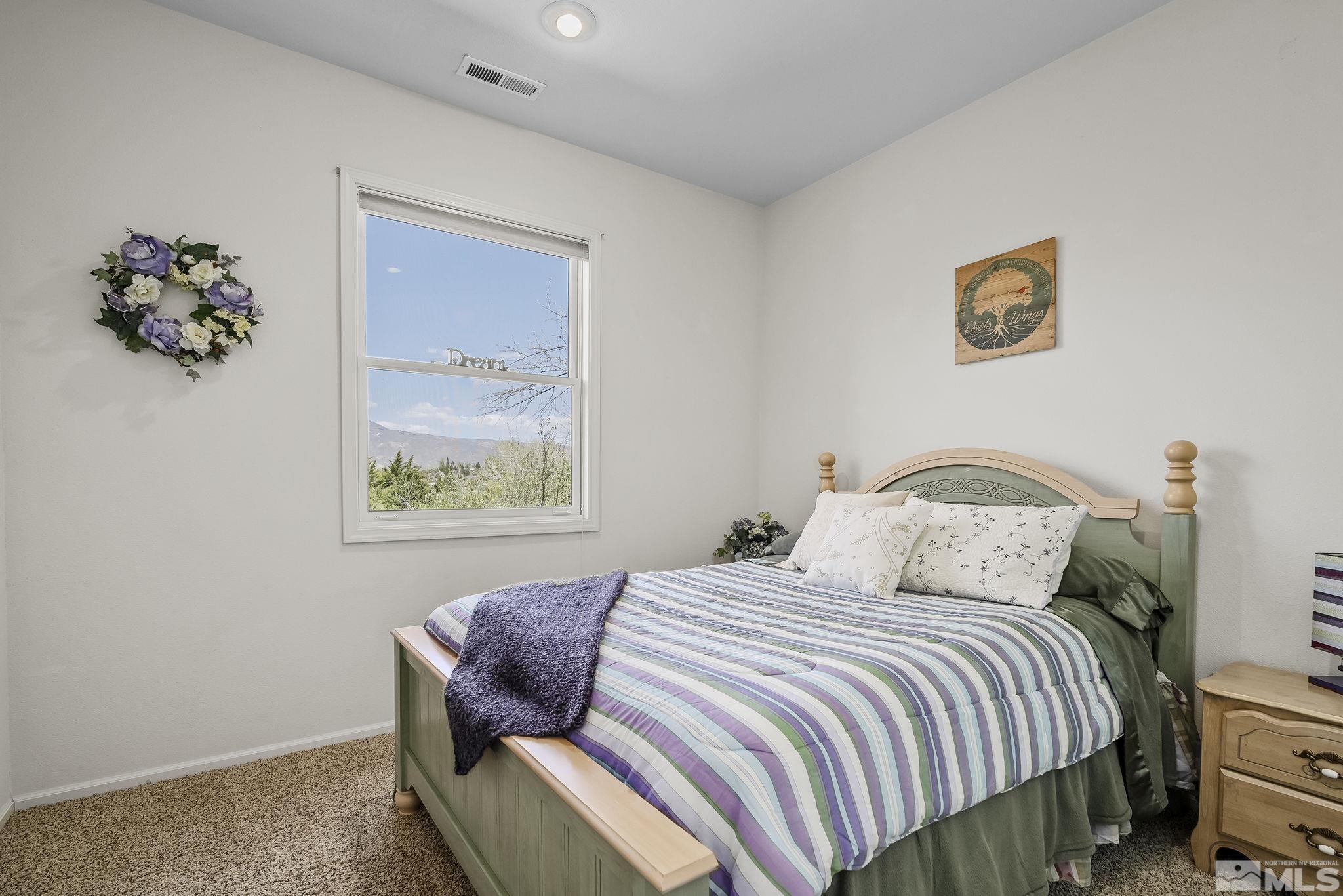 29 Sawbuck Road Reno, NV 89519 - Photo 29 of 40 a bedroom with a bed and a painting on the wall