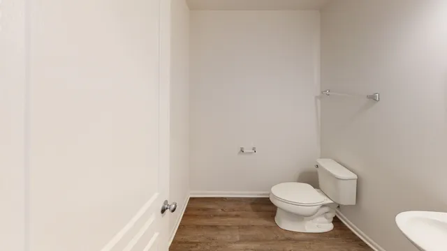 a white toilet sitting next to a shower