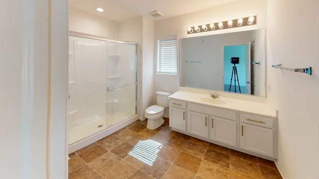 a spacious bathroom with a double vanity sink and a mirror