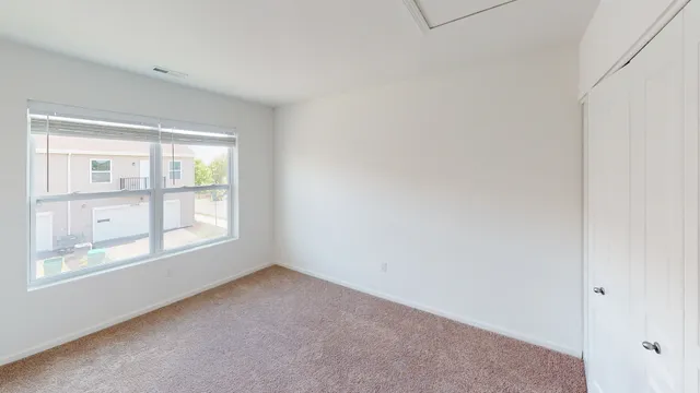 a view of an empty room with a window