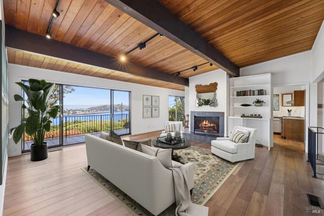 a living room with furniture fireplace and flat screen tv