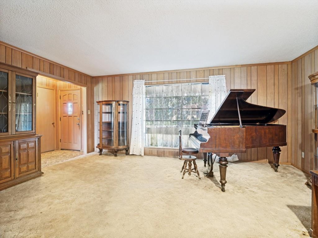 1081 Wright Street Terrell, TX 75160 - Photo 8 of 29 Living space featuring wood-paneled walls and a large window