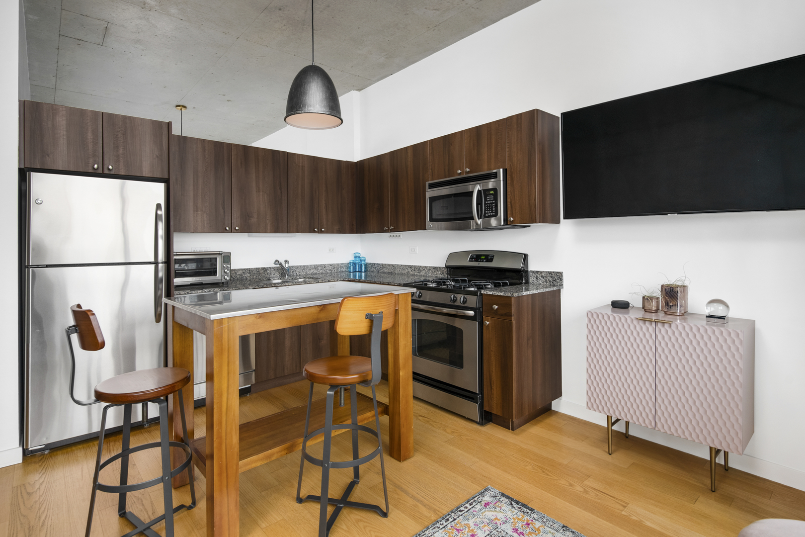 235 West Van Buren Street, Unit 2009 Chicago, IL 60607 - Photo 8 of 14 a kitchen with stainless steel appliances a stove a sink and a microwave