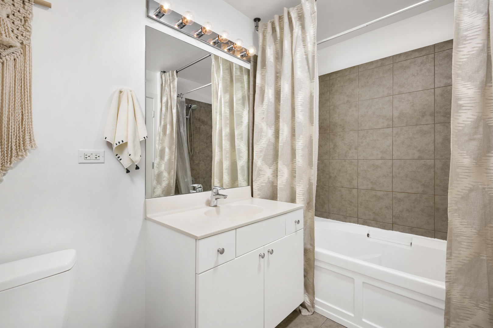 235 West Van Buren Street, Unit 2009 Chicago, IL 60607 - Photo 10 of 14 a bathroom with a sink and a mirror