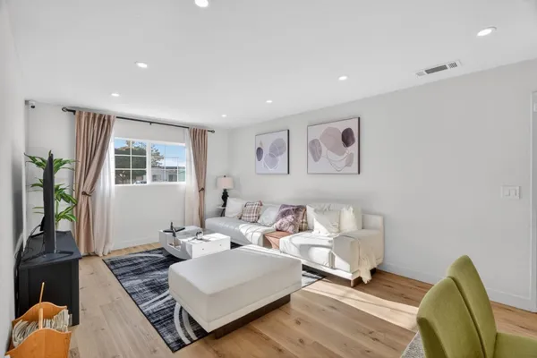 a living room with furniture rug and window
