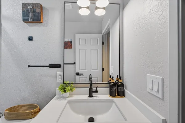 a bathroom with a sink and a mirror