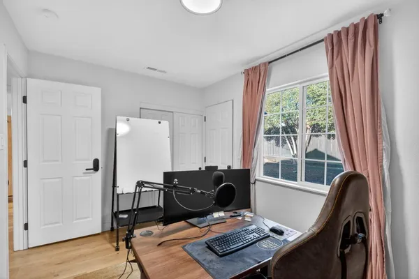 a view of a workspace with furniture and a window