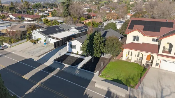 an aerial view of residential houses with outdoor space