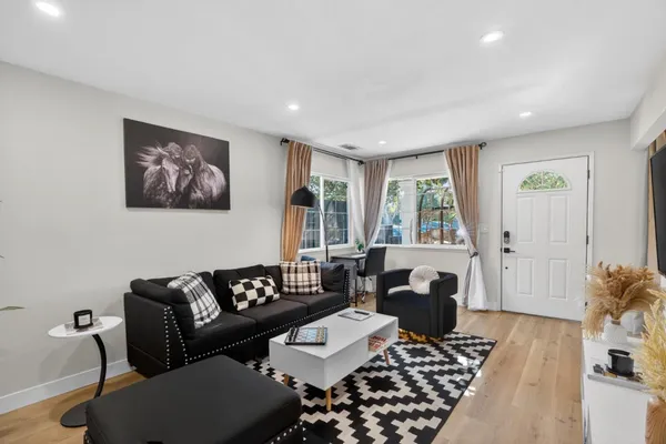 a living room with furniture and wooden floor