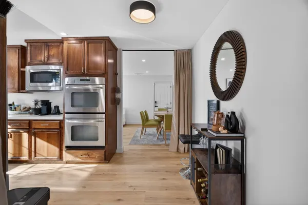 a kitchen with stainless steel appliances granite countertop a stove a sink and a microwave