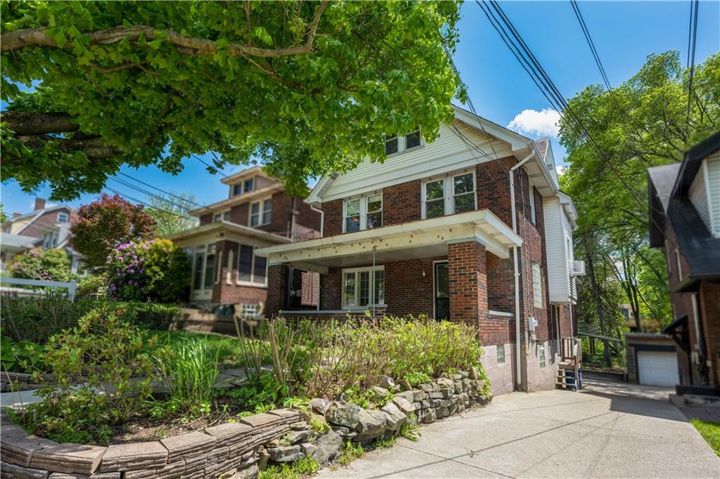 6418 Landview Road Pittsburgh, PA 15217 - Photo 2 of 24 a front view of a house with a garden