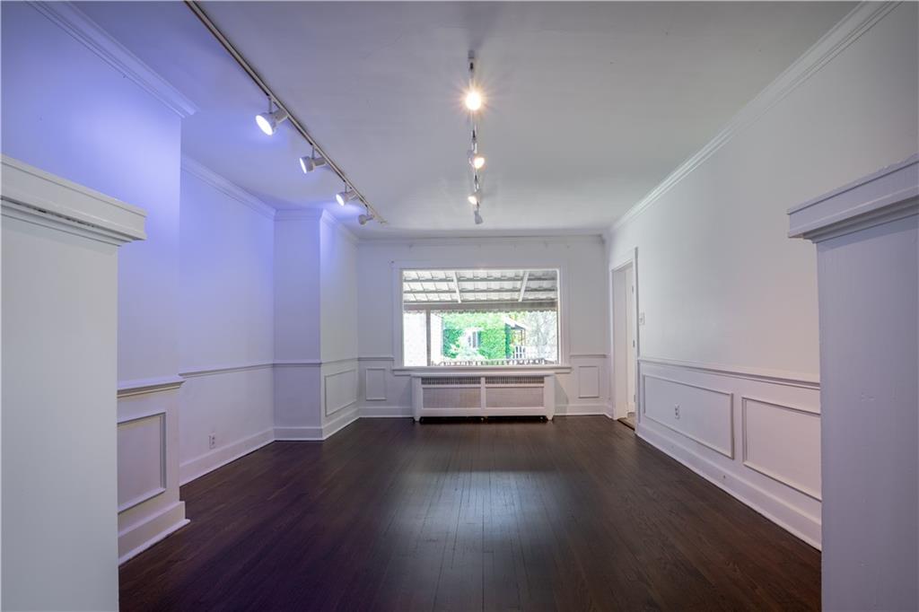 6418 Landview Road Pittsburgh, PA 15217 - Photo 8 of 24 an empty room with wooden floor and windows with curtains
