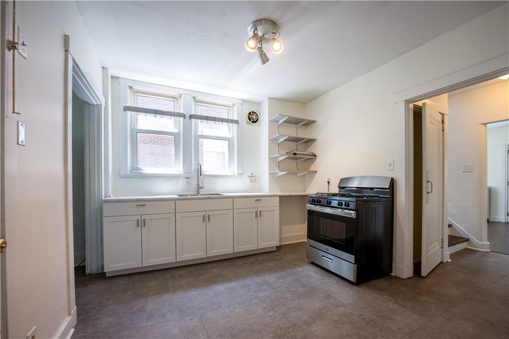 6418 Landview Road Pittsburgh, PA 15217 - Photo 9 of 24 a kitchen with granite countertop white cabinets and stainless steel appliances