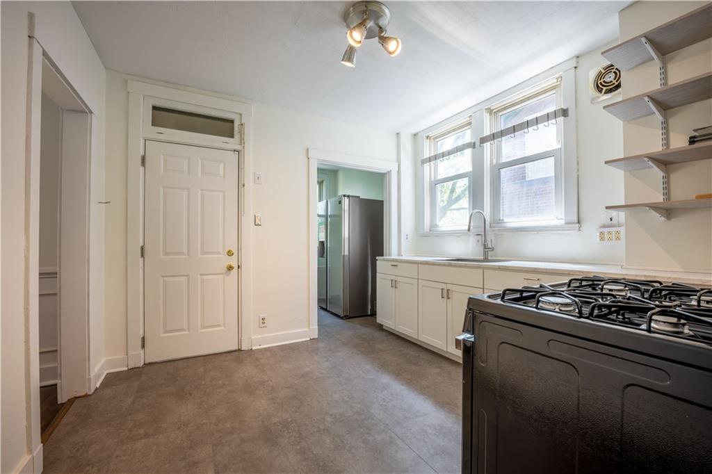 6418 Landview Road Pittsburgh, PA 15217 - Photo 10 of 24 a kitchen with a stove and a cabinet