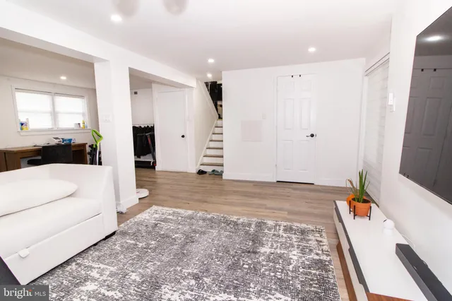 a view of a bedroom with a bed and wooden floor