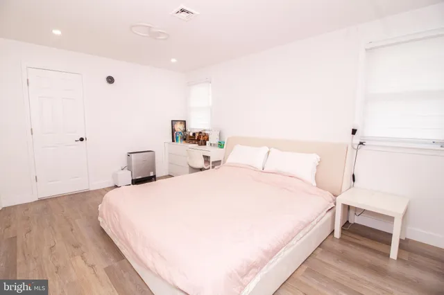 a bed room with a bed and a chair