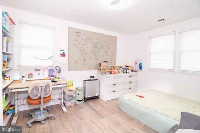 a room with furniture a baby crib and a window