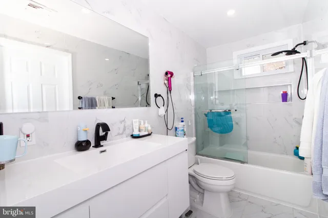 a bathroom with a sink a toilet and a shower