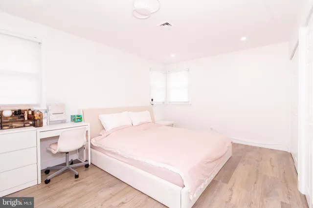 a bedroom with a bed and a desk