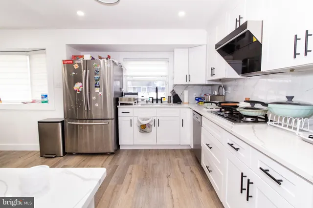 a kitchen with a sink cabinets and stainless steel appliances