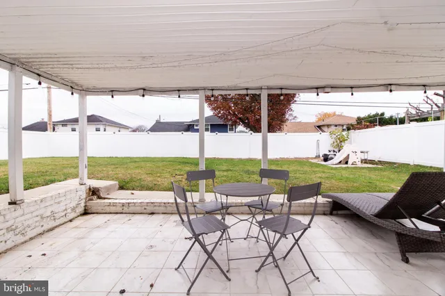 a view of a patio with a table chairs and a patio