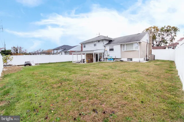a view of a house with a big yard and large trees