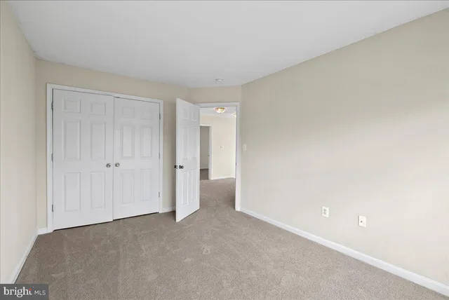 a bathroom with a granite countertop sink a toilet a mirror and shower