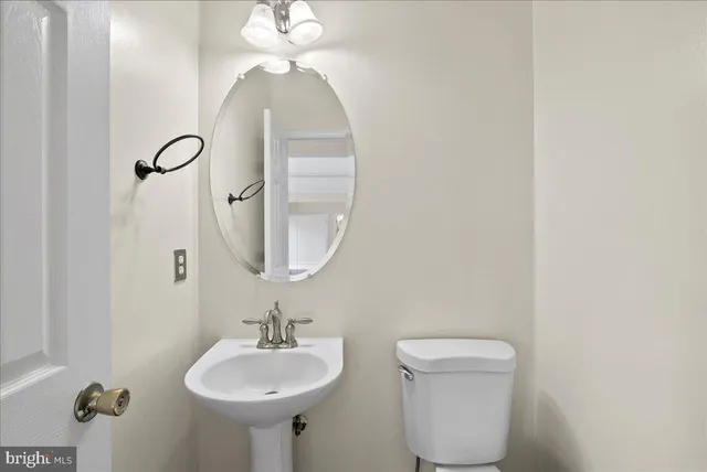 a bathroom with a sink a mirror and a toilet