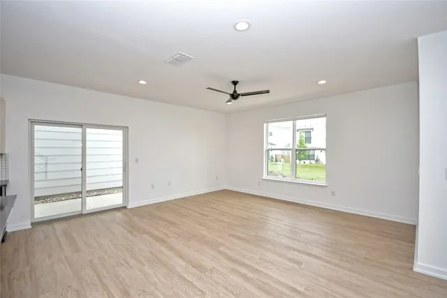 an empty room with windows and closet