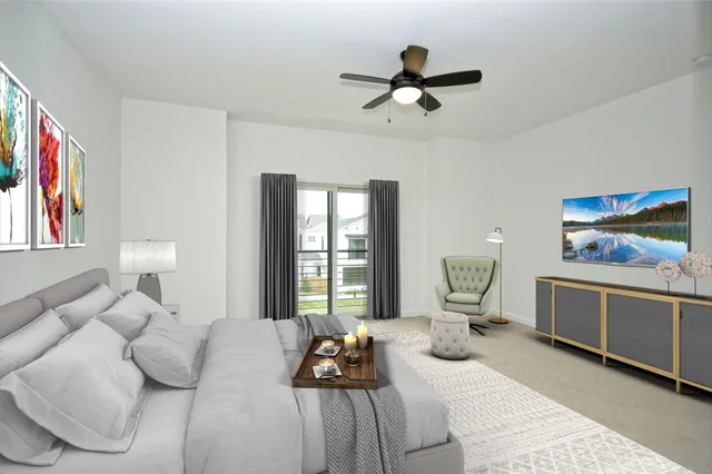 a bedroom with furniture and a large window