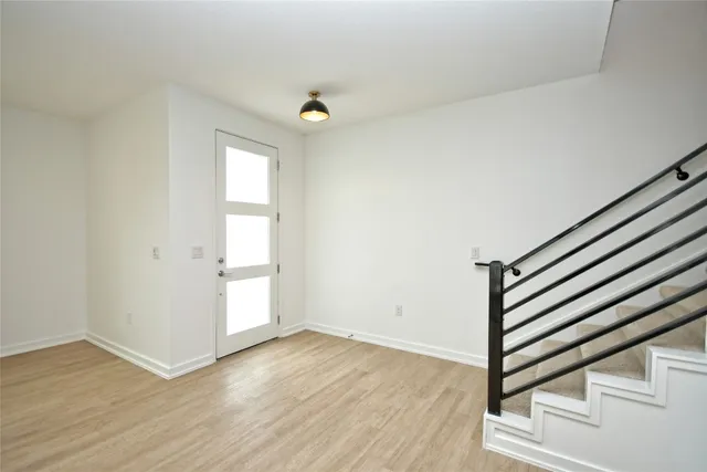 an empty room with wooden floor