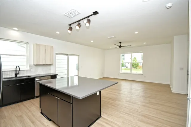 a kitchen with granite countertop a sink and cabinets