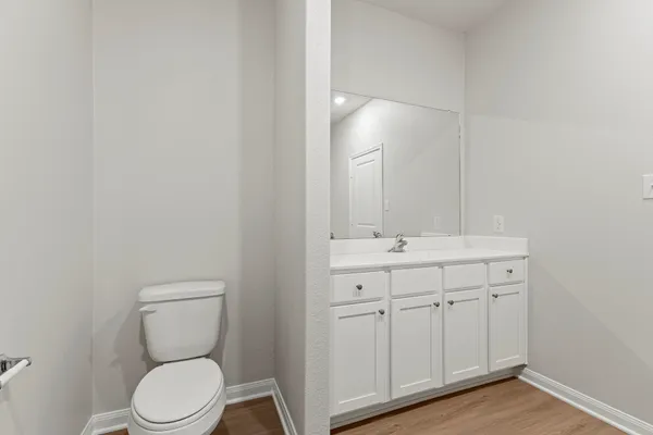 a bathroom with a toilet a sink and mirror