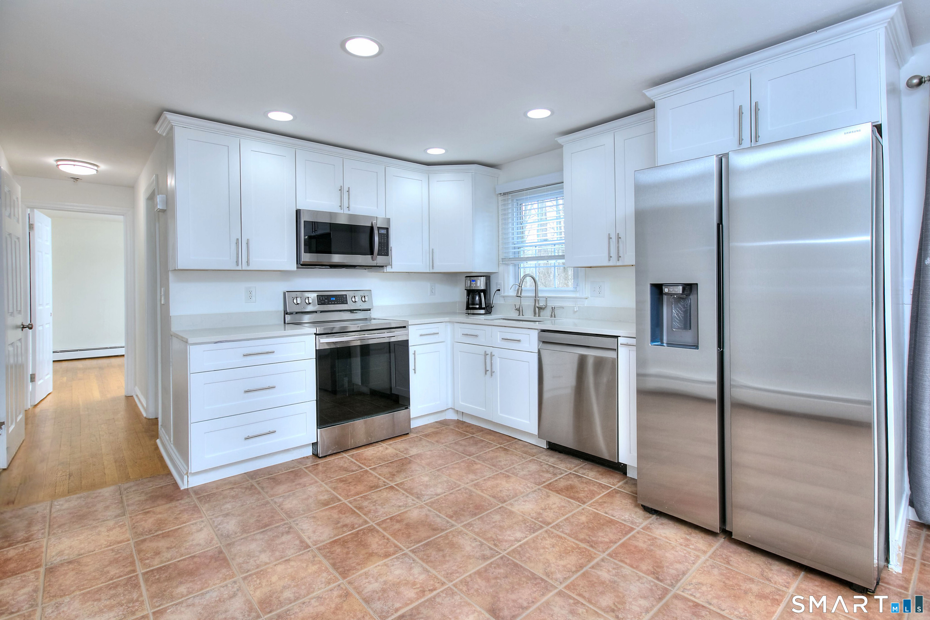 46 Crest Road Ridgefield, CT 06877 - Photo 11 of 41 a kitchen with white cabinets and stainless steel appliances