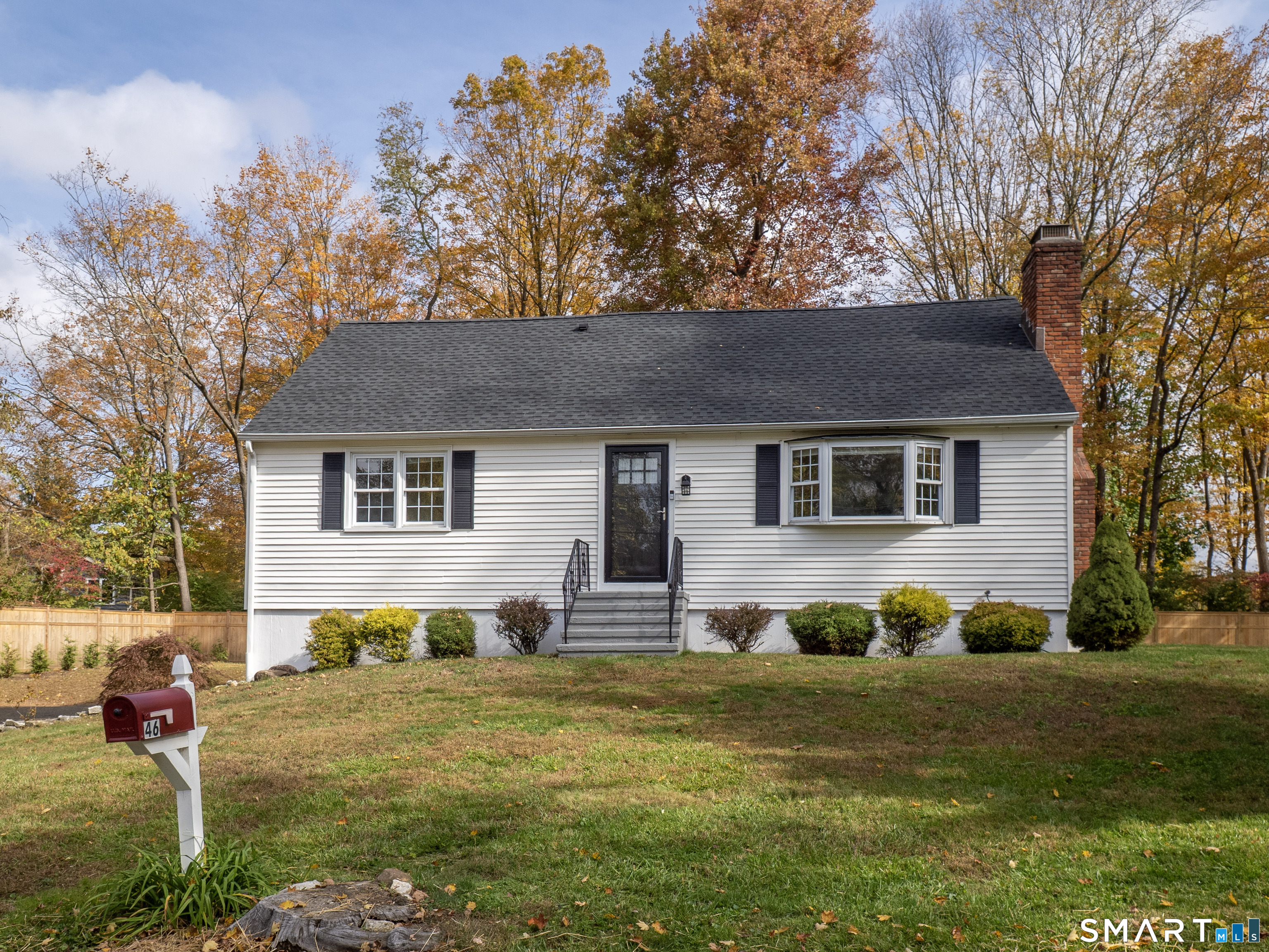 46 Crest Road Ridgefield, CT 06877 - Photo 2 of 41 a front view of a house with a garden