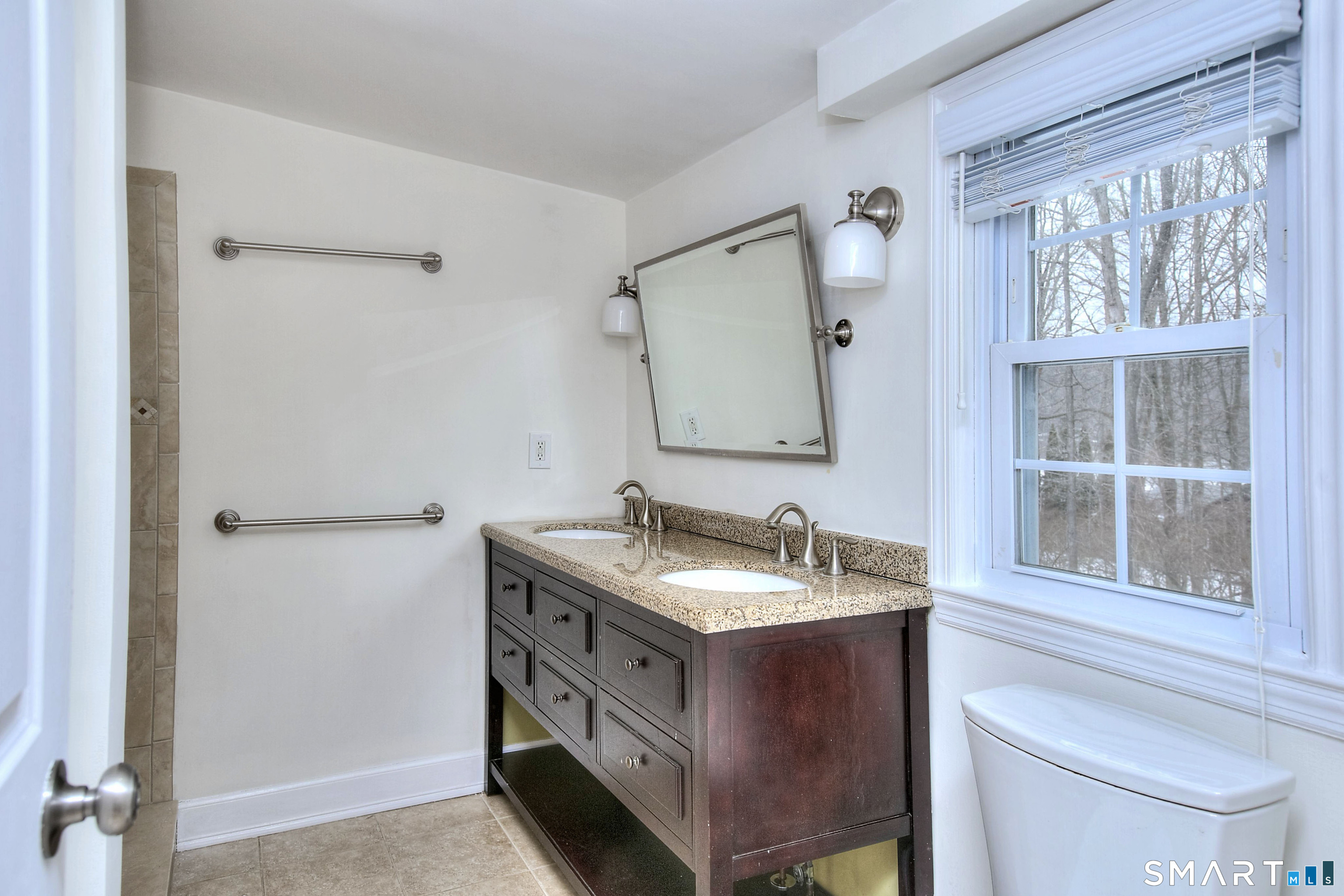 46 Crest Road Ridgefield, CT 06877 - Photo 21 of 41 a bathroom with a granite countertop sink and a mirror