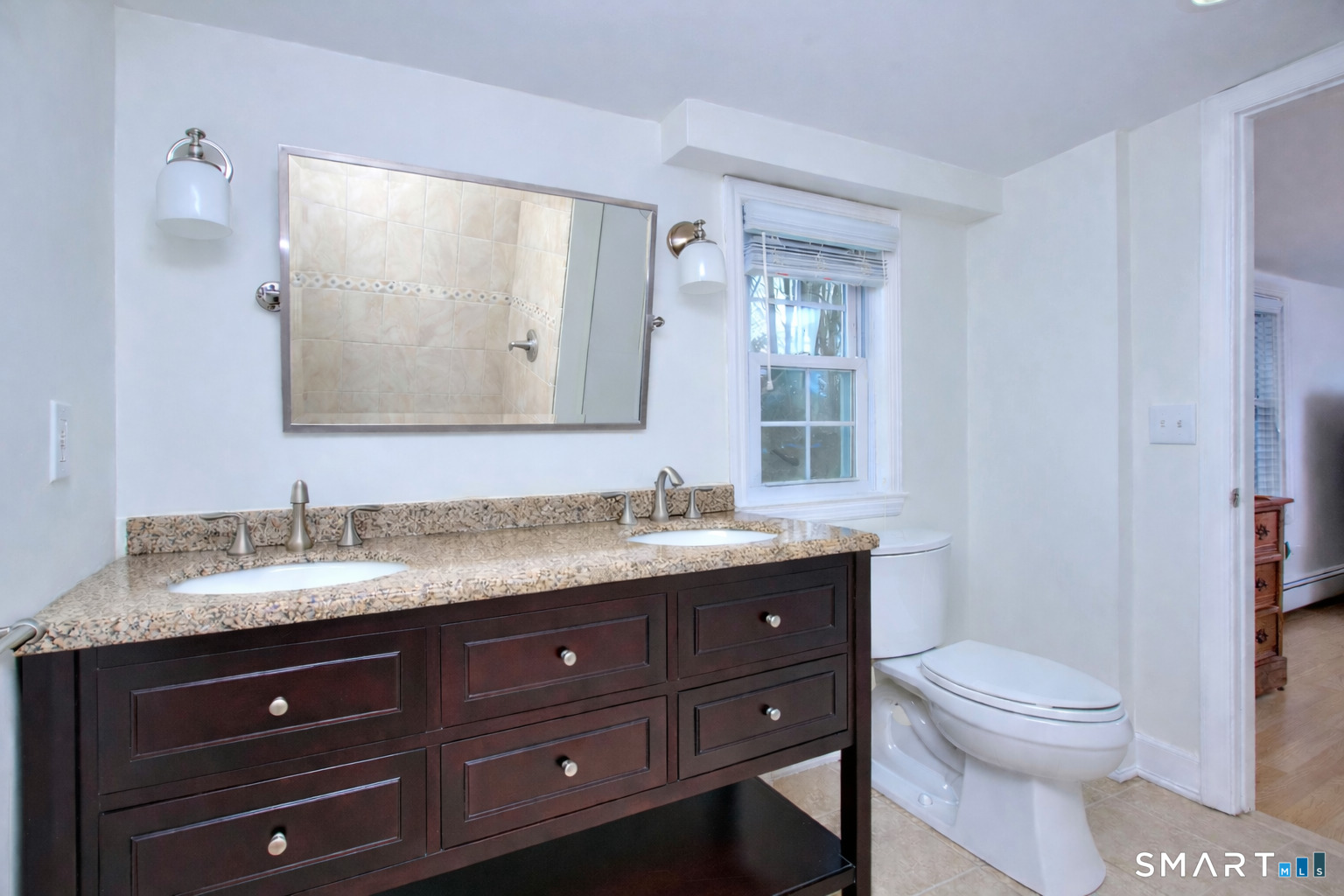 46 Crest Road Ridgefield, CT 06877 - Photo 23 of 41 a bathroom with a granite countertop toilet sink and mirror