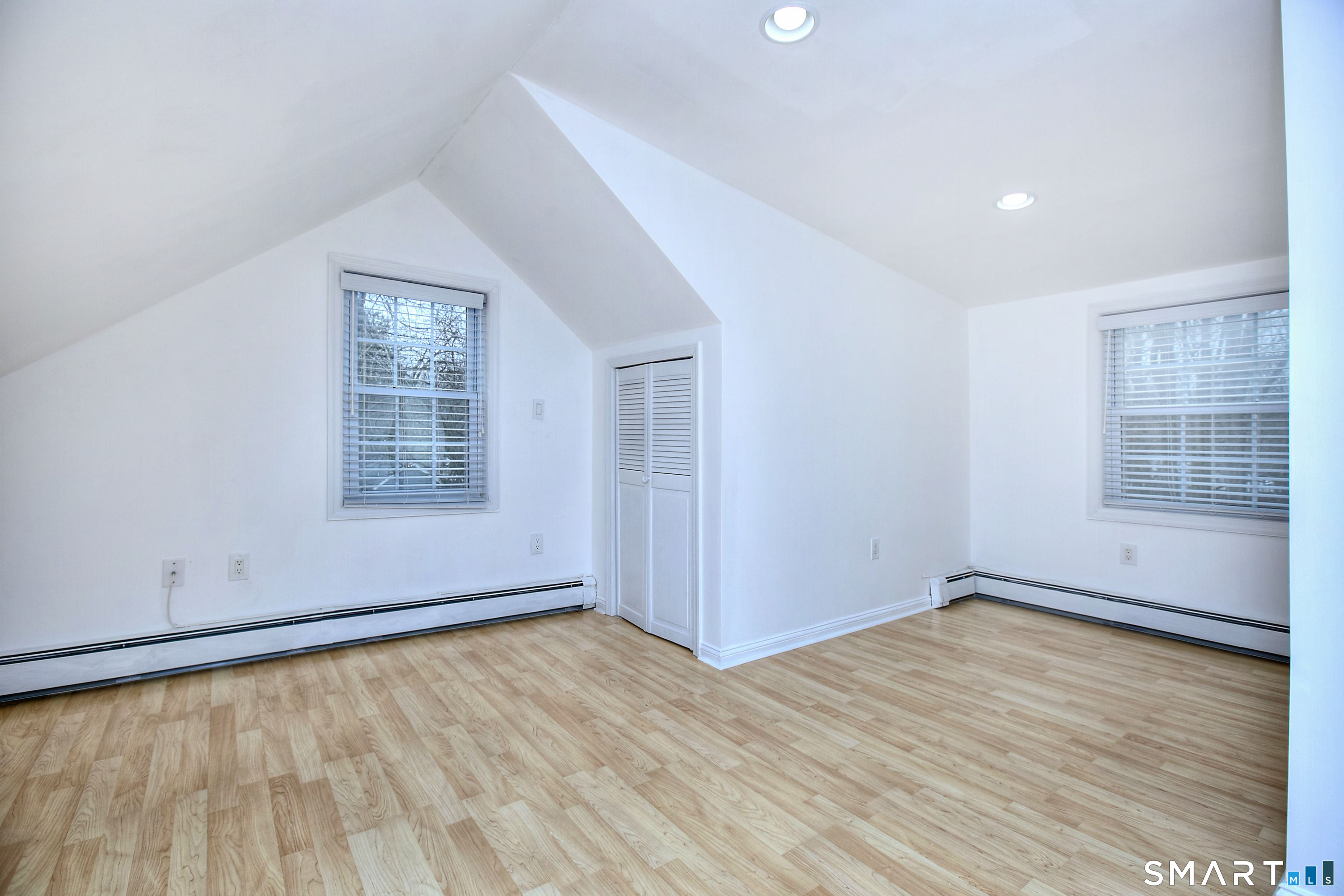 46 Crest Road Ridgefield, CT 06877 - Photo 25 of 41 an empty room with wooden floor and windows