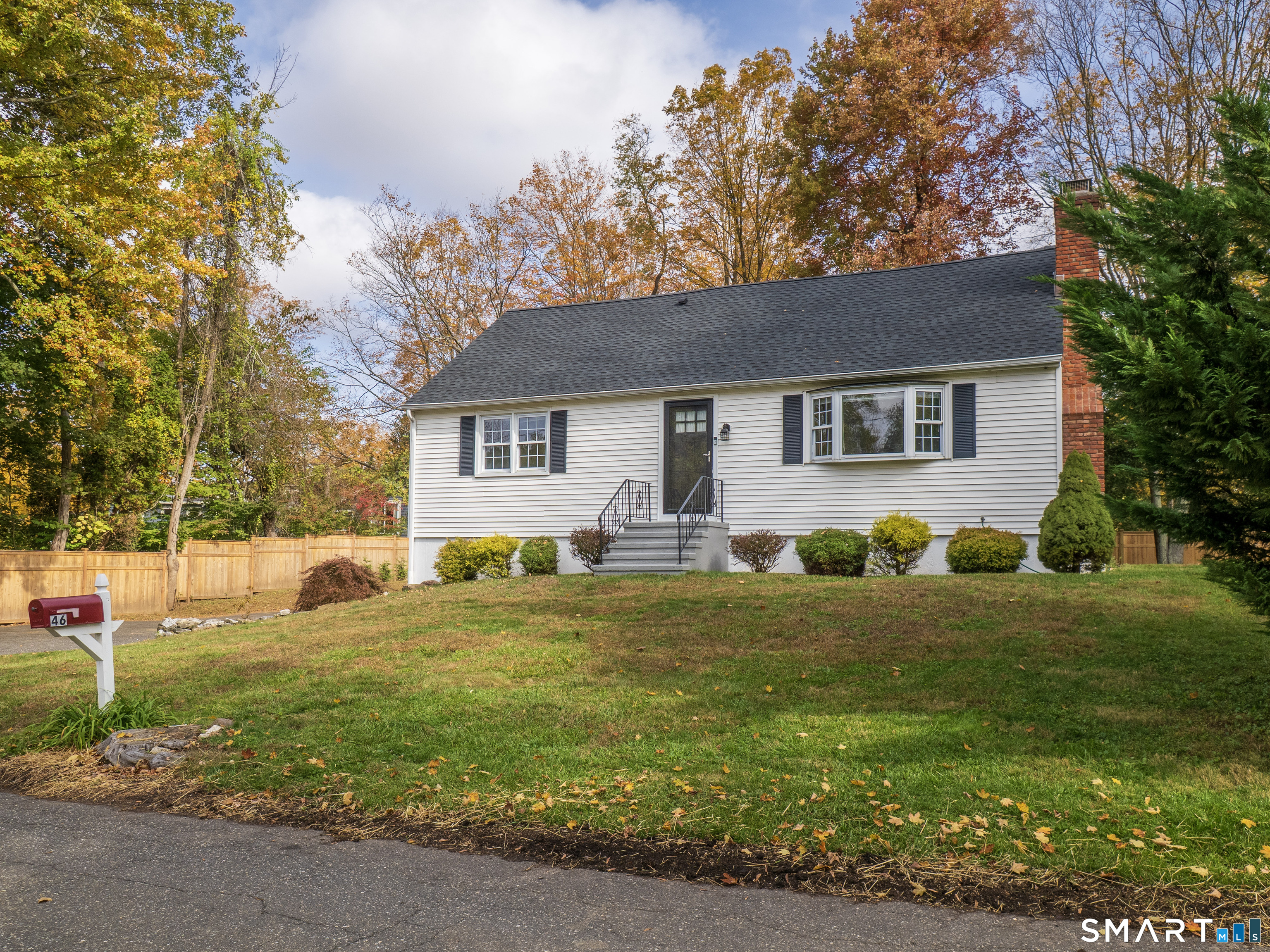 46 Crest Road Ridgefield, CT 06877 - Photo 41 of 41 a front view of house with yard and trees in the background