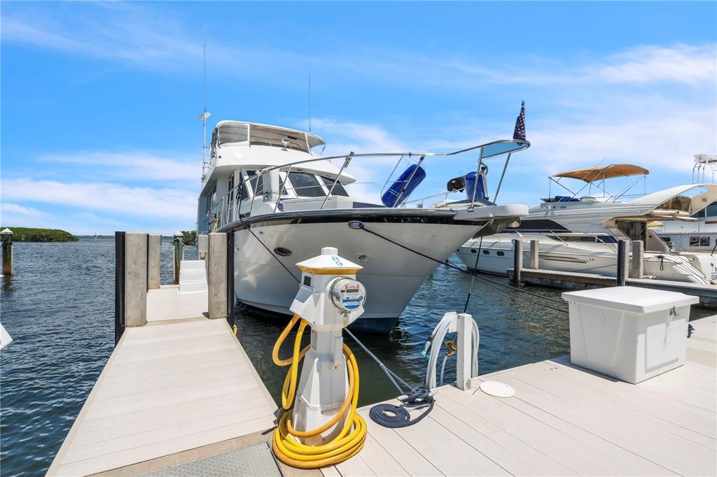2600 Harbourside Drive, Unit R9 Longboat Key, FL 34228 - Photo 12 of 26 a view of a roof deck with table and chairs with wooden floor