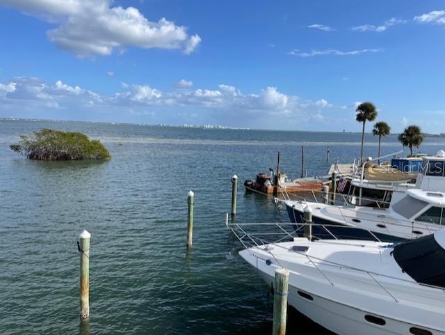 2600 Harbourside Drive, Unit R9 Longboat Key, FL 34228 - Photo 13 of 26 a terrace with food on dining table