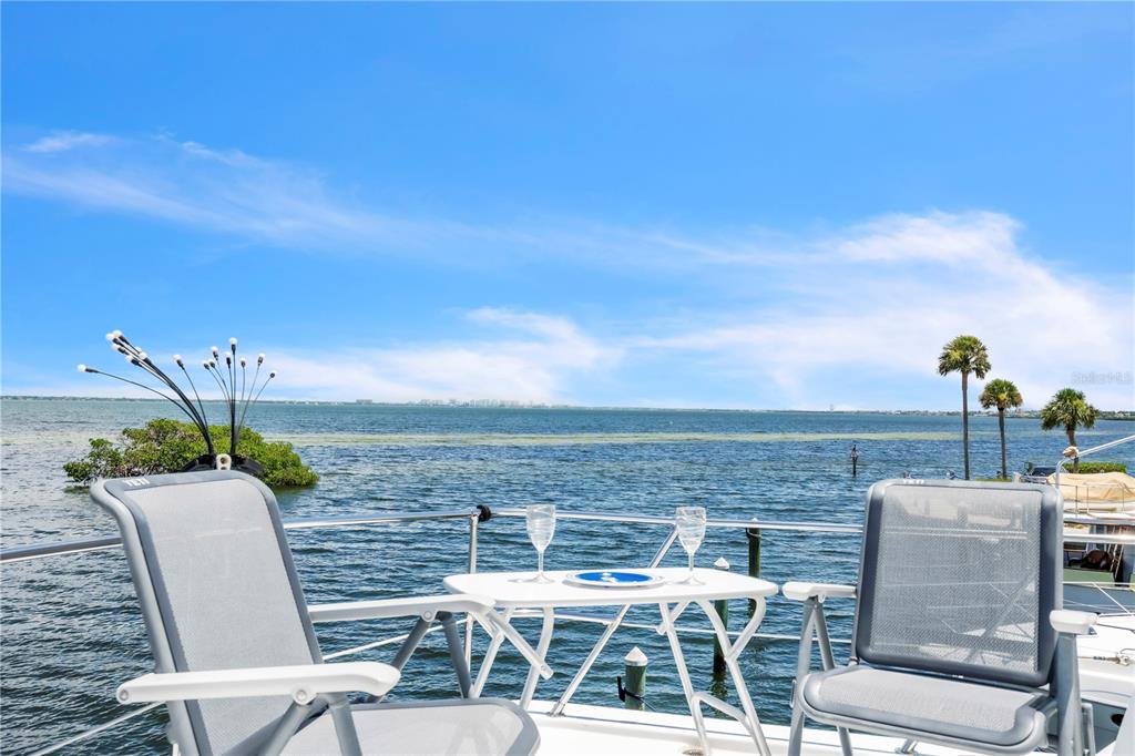 2600 Harbourside Drive, Unit R9 Longboat Key, FL 34228 - Photo 14 of 26 a view of an chairs and table on the terrace