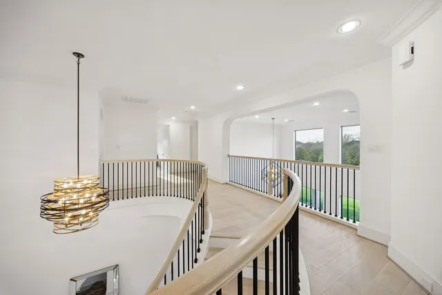 a view of a hallway with bed and furniture