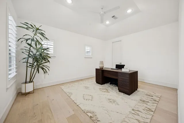 a view of a hallway with wooden floor and entryway