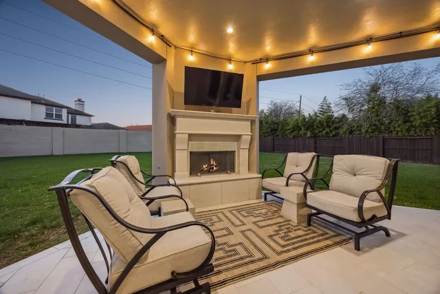 a view of an outdoor dining space with a table and chairs